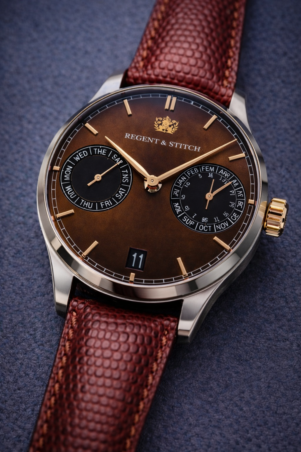 Watch with brown leather strap and detailed face on a dark blue background